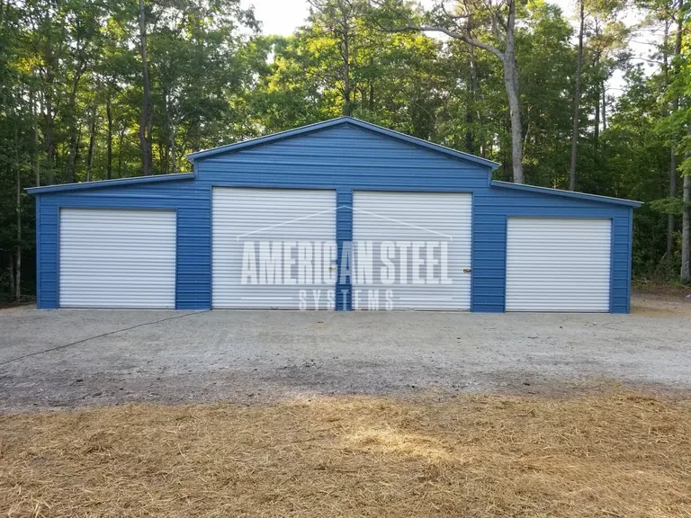 Blue steel barn with four roll-up doors