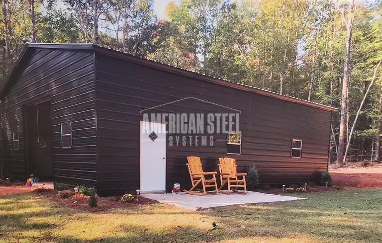 Dark brown steel garage with a patio
