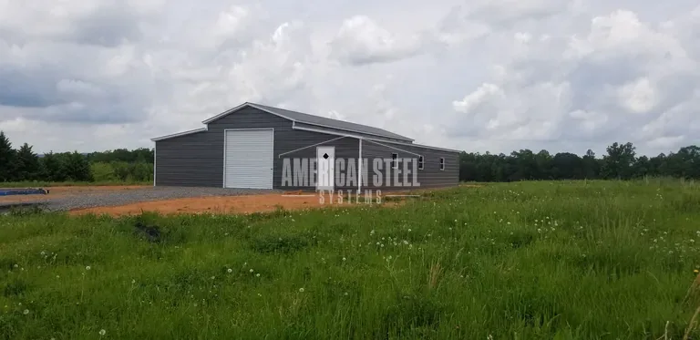 Long gray steel barn in an open field