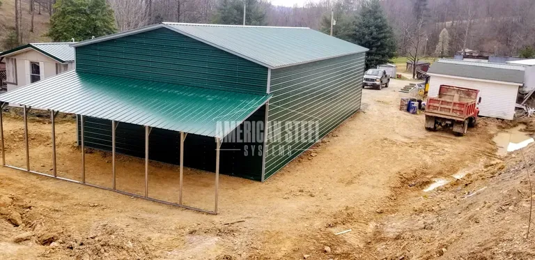 Green steel building with open lean-to