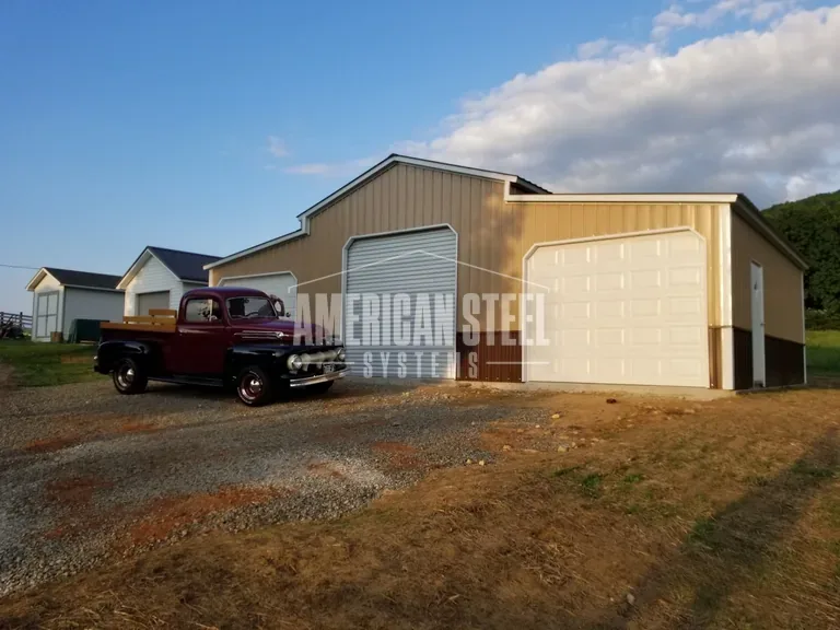 Tan steel barn with enclosed lean-to